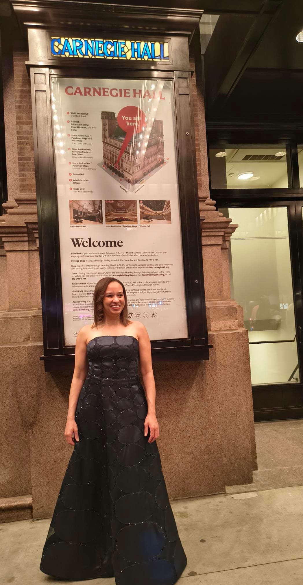 Nina Kidd with the Carnegie Hall event poster